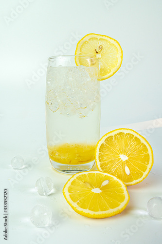 Fresh lemon soda drink iced with lemon sliced on white background.