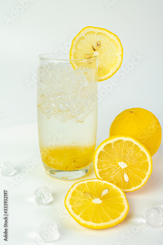 Fresh lemon soda drink iced with lemon sliced and jam on white background.