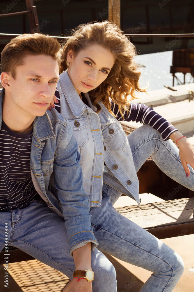 Young couple man and woman in jeans clothes at daylight