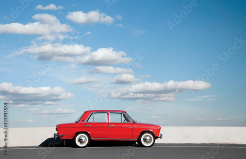 Red retro car VAZ-2103 "Zhiguli" parked on the road against the background of the sunny sky at Old Car Fest show, JULY 4, 2016 in Kiev, Ukraine. Space for text. © Ivan
