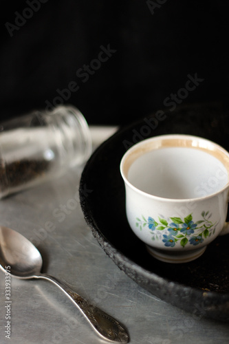 blank white cup on dark background,  teaspoon