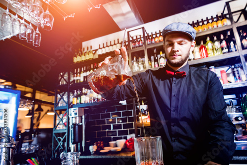 Bartender is making cocktail at bar counter. Fresh cocktails.  © romaset