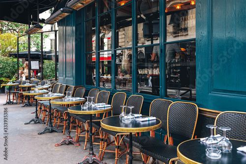 Tables and chairs in outdoor cafe in Paris, France. photo