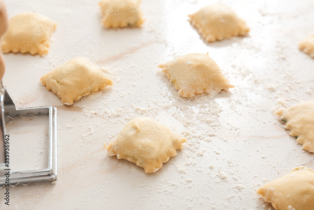Raw ravioli with stamp on white background Raw ravioli with stamp on white background
