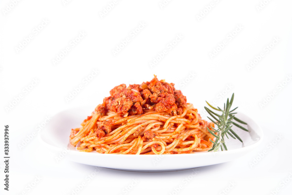 Spaghetti bolognese on a plate decorated with a rosemary twig Spaghetti bolognese on a plate decorated with a rosemary twig