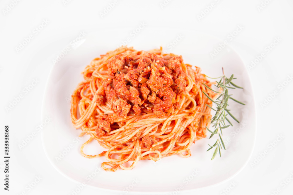 Spaghetti bolognese on a plate decorated with a rosemary twig Spaghetti bolognese on a plate decorated with a rosemary twig