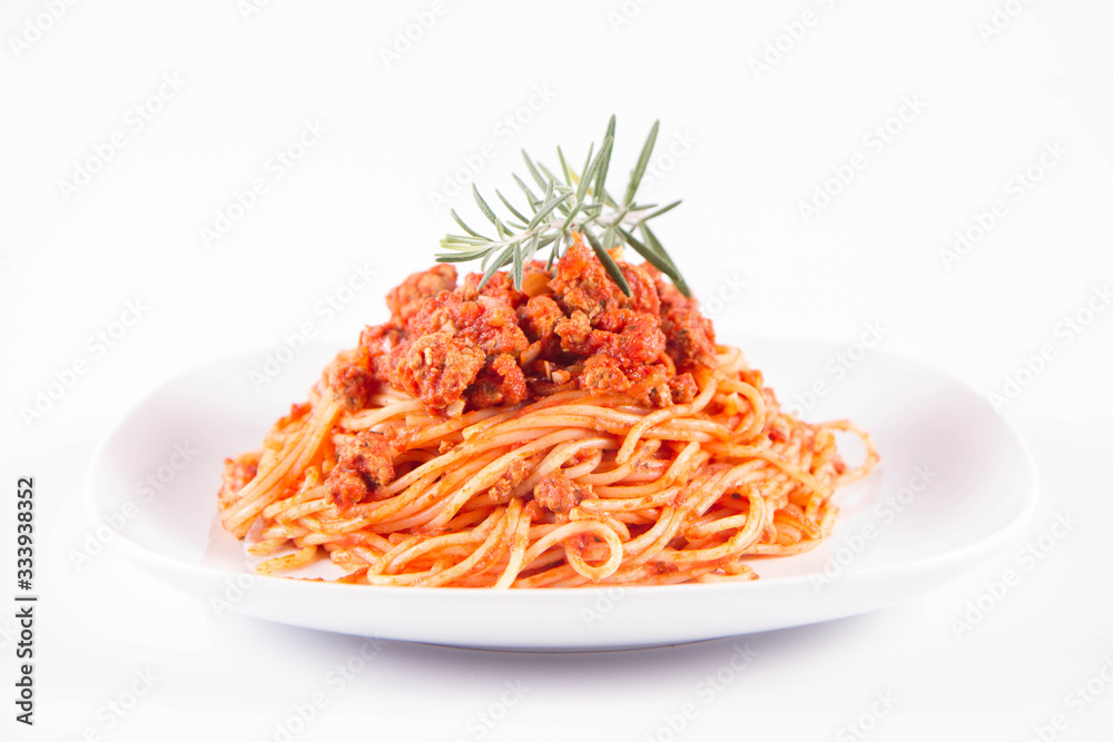 Spaghetti bolognese on a plate decorated with a rosemary twig Spaghetti bolognese on a plate decorated with a rosemary twig