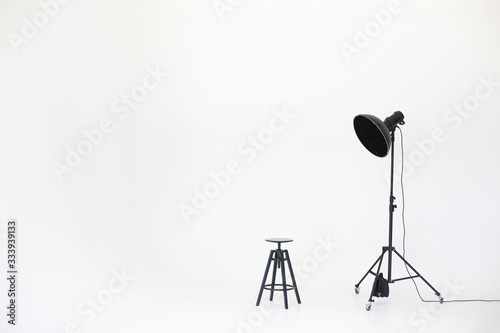 Foto Wooden chair with lighting equipment isolated on a white background