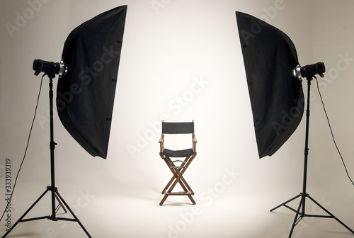 Empty photo studio with lighting equipment. Space for text. Vacant chair. The concept of selection and casting. Screensaver for your desktop.