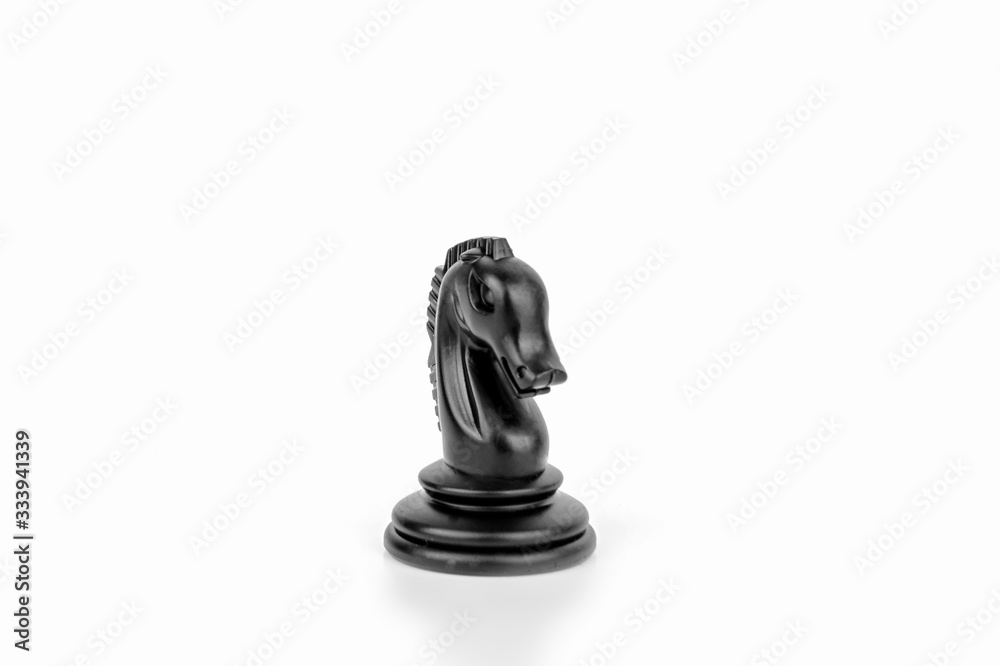 Black chess piece horse isolated on a white background. The concept of board games, logic, training for the brain.