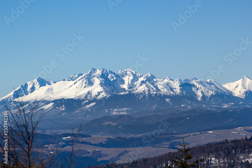 High Tatras in early spring. View from Jaworzyna Krynicka Mountain in Beskid Sadecki.
