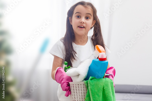 Fotografie Little housekeeping fairy girl doing home chores