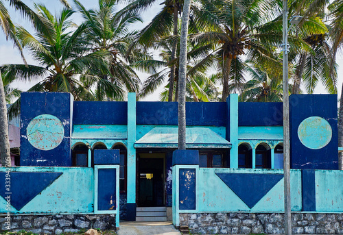 Old modern white and blue building with damaged walls in Kovalam © Rostyslav