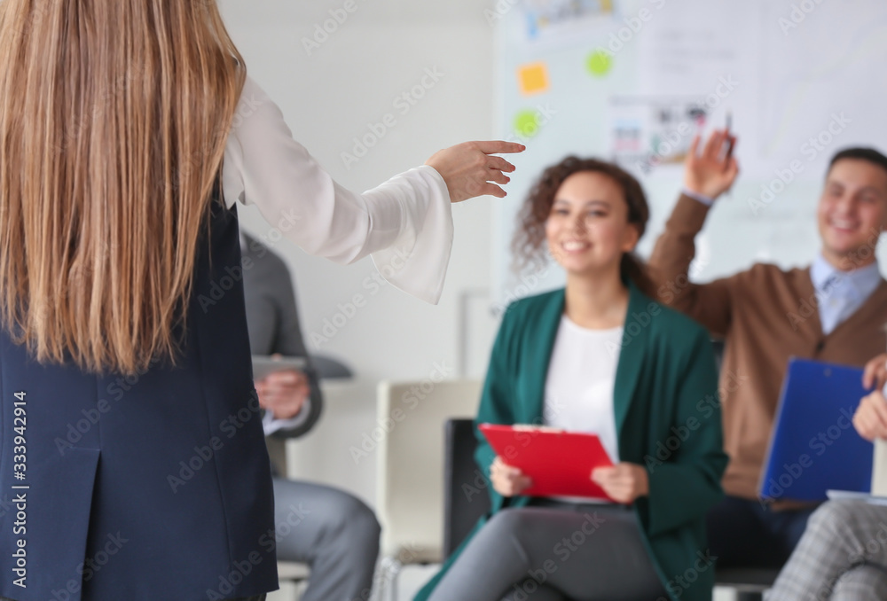 Female interior designer teaching young people in office Female interior designer teaching young people in office