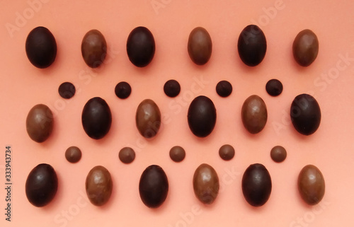 Several chocolate eggs on a peach background in a separate pattern