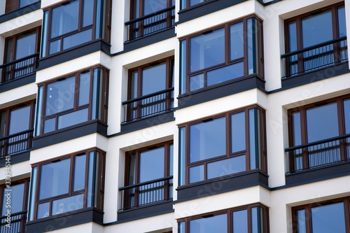 Urban lifestyle. Facade of new modern residential house. Apartment building in the city. 