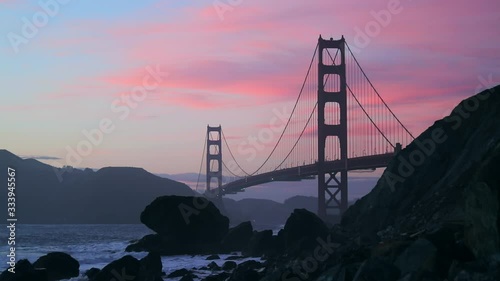 A beautiful cinematic footage of Golden Gate Bridge during the sunset time. Golden hour at San Francisco in California. Historical architecture of United States of America