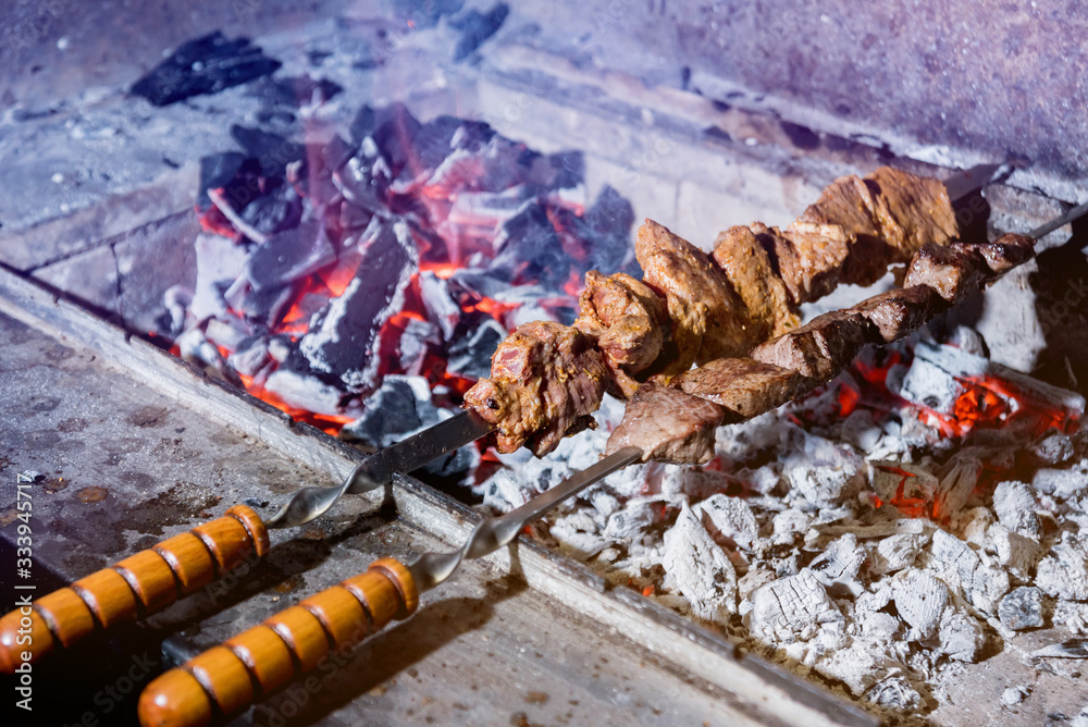 Obraz premium Delicious beef and pork barbecue on grill. Georgian restaurant.