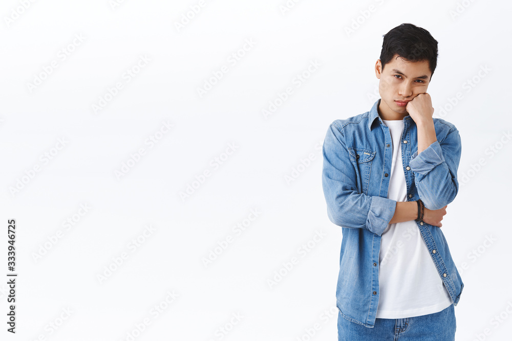 Portrait of bored young asian guy homesick, staying isolated in house during quarantine covid-19, lean on palm, look camera annoyed, watching boring movie, stand white background Portrait of bored young asian guy homesick, staying isolated in house during quarantine covid-19, lean on palm, look camera annoyed, watching boring movie, stand white background