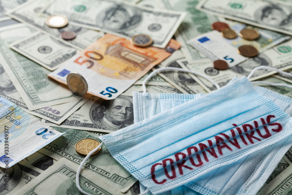 Medical face mask and money, world coronavirus epidemic and economic losses concept. Medical face mask and money, world coronavirus epidemic and economic losses concept.