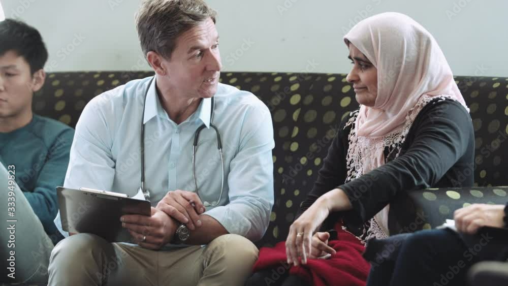 Doctor consulting patient in hospital waiting room Doctor consulting patient in hospital waiting room