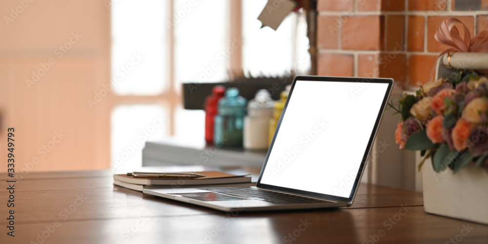 Computer laptop with white blank screen putting on wooden table with ...