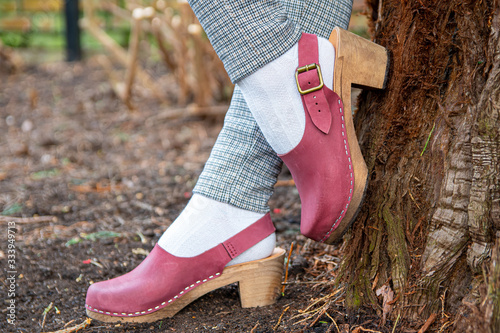 Fotografie Beautiful women's wooden clog shoes with plum purple nubuck leather