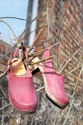 Canvas Print Beautiful women's wooden clog shoes with plum purple nubuck leather
