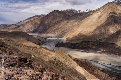 Beautiful landscape of river and mountains hill along the road on the way to Diskit village in Ladakh, Jammu and Kashmir, India