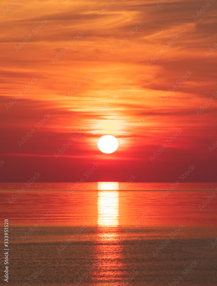 Peaceful orange red sea sunrise (vertical)