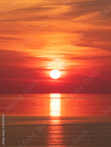 Peaceful orange red sea sunrise  vertical 