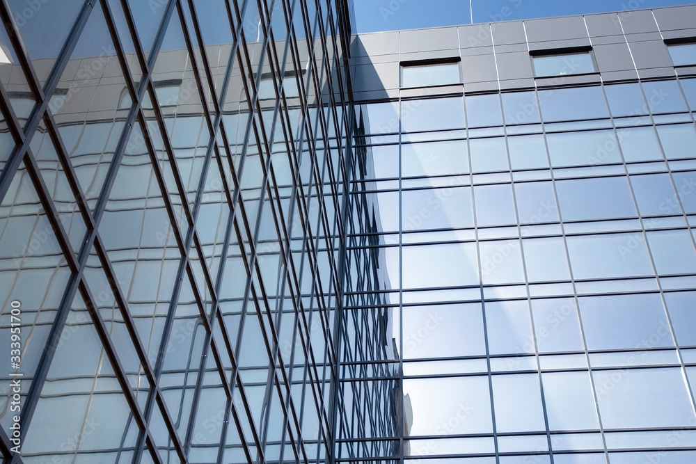 Obraz premium Abstract texture and blue glass facade in modern office building. 