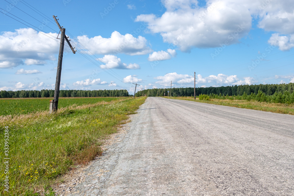 rickety electric poles standing along the road rickety electric poles standing along the road