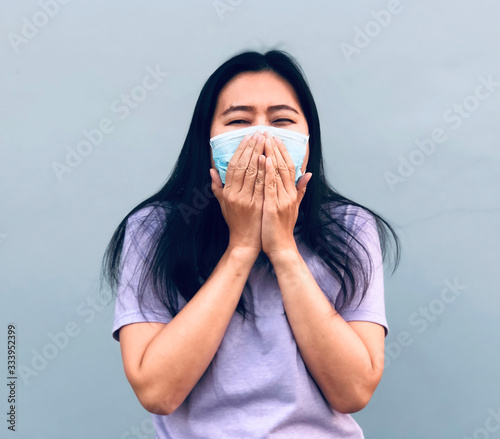Asian women have A cold, cough and sneeze, Wear protective masks,sickness . Conception about health-care.