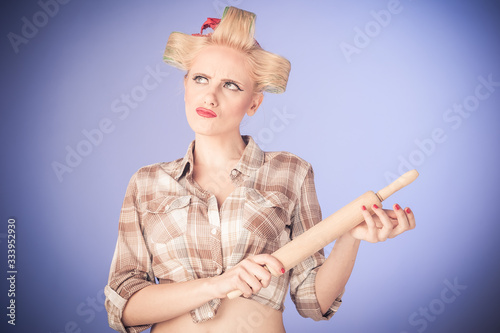 Pin up young housewife with rolling pin