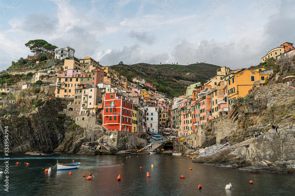 Stunning view of colorful Riomaggiore village at sunset in Cinque Terre, Italy.