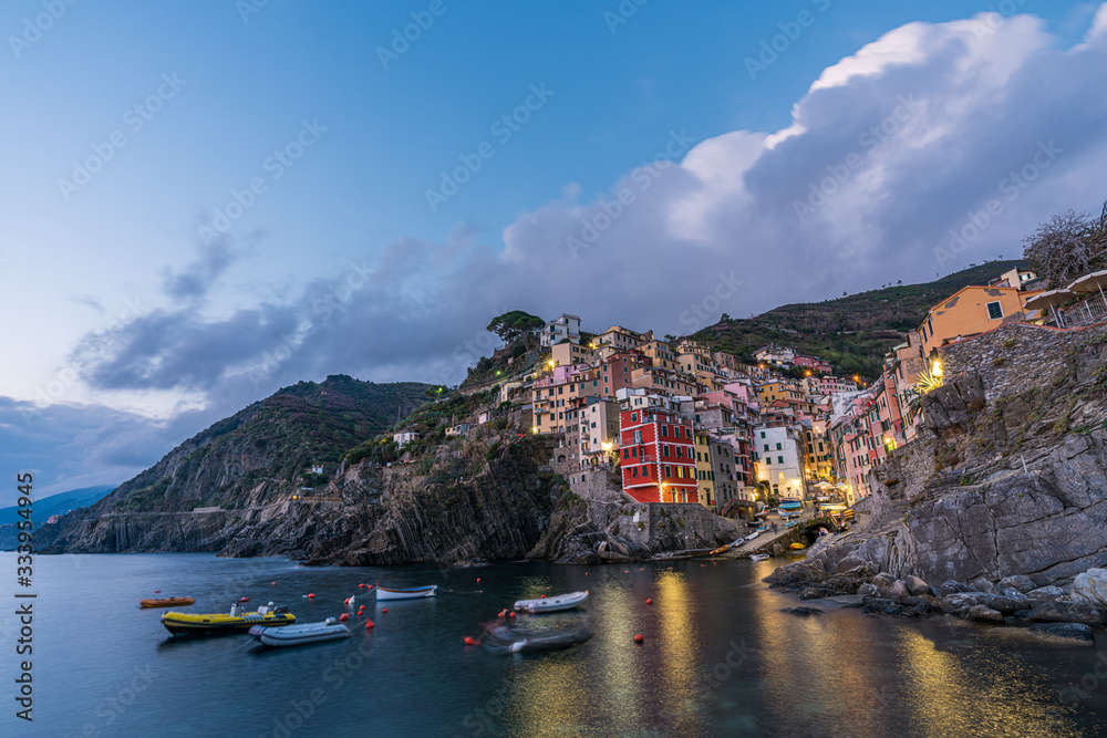 Riomaggiore town on Italian coastline at sunset in Cinque Terre, Italy