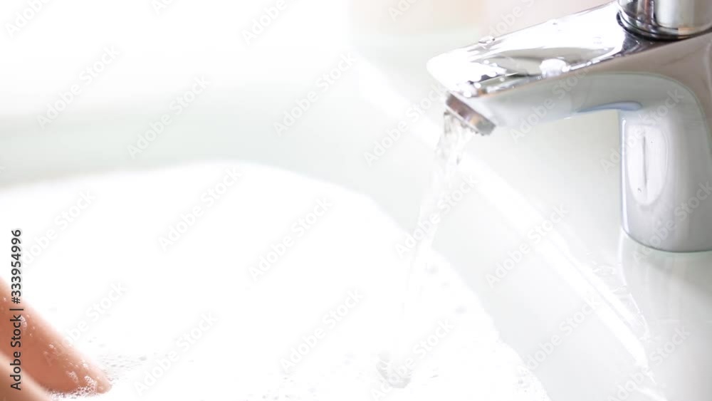 Father helps wash his little son's hands with soap on faucet. the pan filled with soap and water. Close-up. coronavirus prevention measures. Father helps wash his little son's hands with soap on faucet. the pan filled with soap and water. Close-up. coronavirus prevention measures.