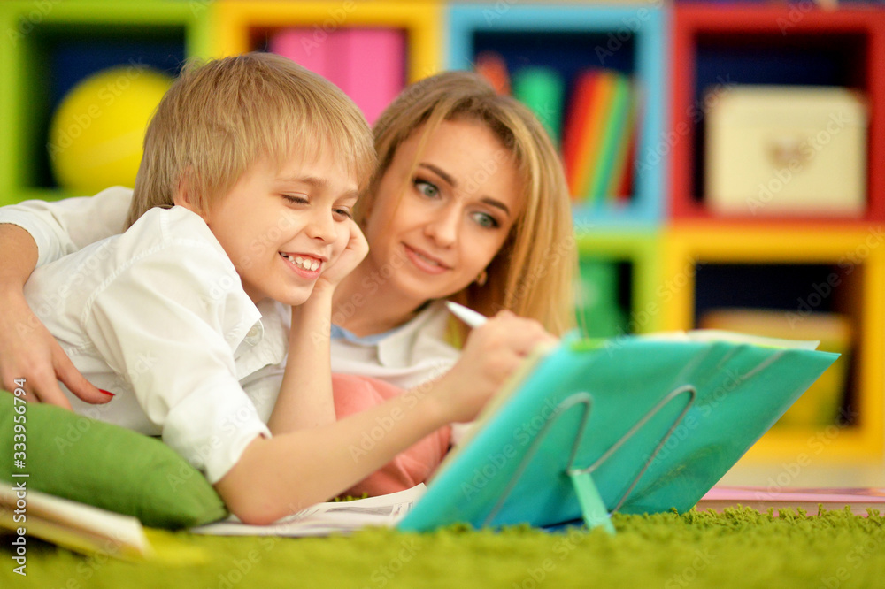 Obraz premium Mother with her son doing homework at home