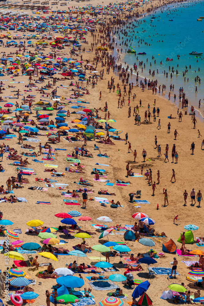 Beach full with people in a summer day in Algarve