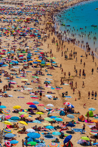 Beach full with people in a summer day in Algarve