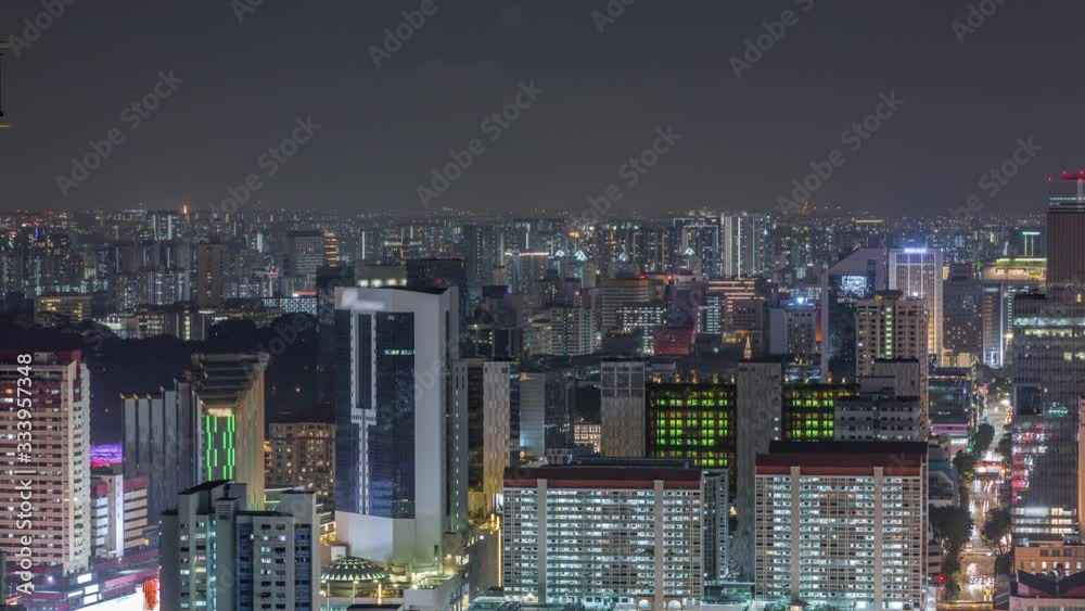 Aerial cityscape of Singapore downtown of modern architecture with skyscrapers night timelapse, view from skybridge viewpoint with traffic on South Bridge road