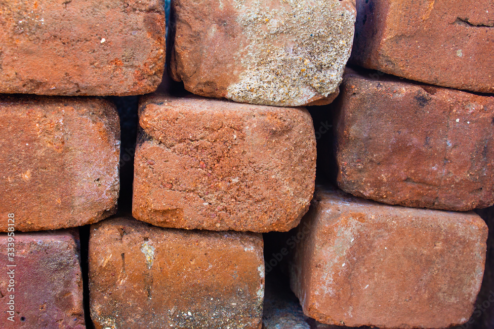 Old bricks used in construction stacked over one another
