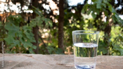 A glass with water on the nature background