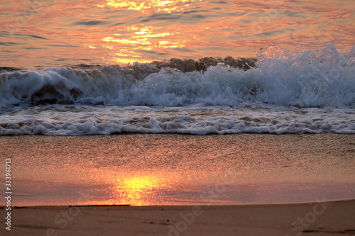 Wave rolling over the sands on Candolim Beach, North Goa, India photo