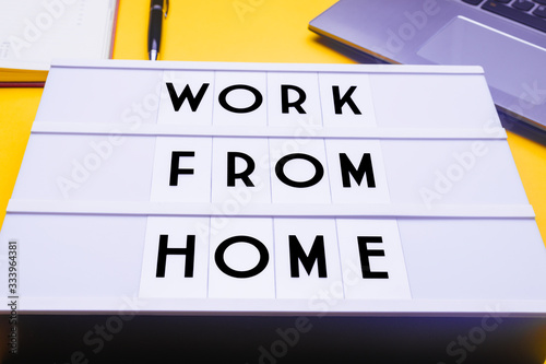 Workspace table with a lichtbox with the words WORK FROM HOME.
