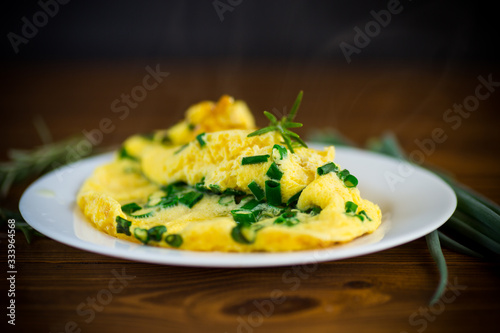 hot fried omelet with chopped green onions in a plate