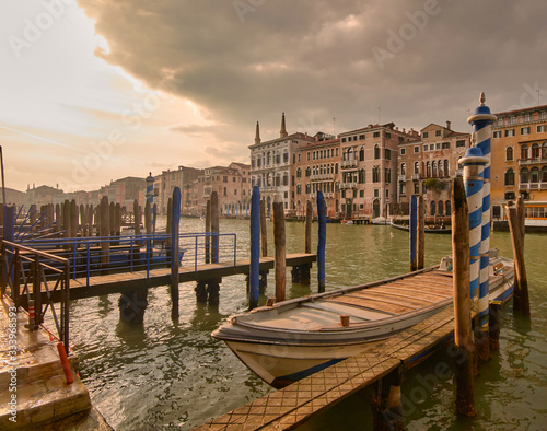 sunset on the grand canal in Venice, after a major storm. Detail of the gondolas and facades close to the great canal.