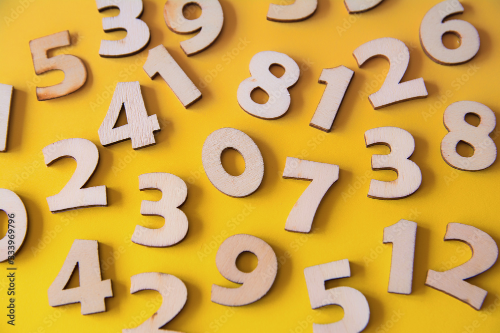 Set of wooden numbers on a yellow background Set of wooden numbers on a yellow background