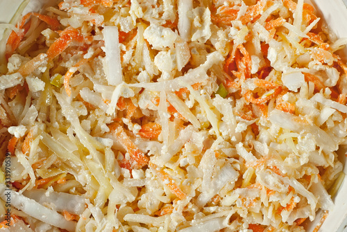 Salad of fresh cabbage, carrots and cheese. Homemade salad in a bowl.